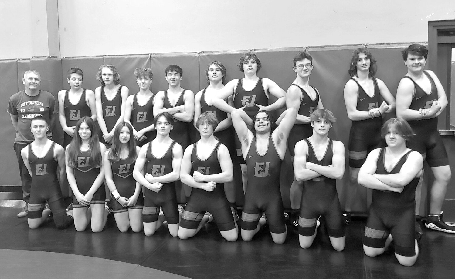 In the past 20 years the combined Chimacum/PT Wrestling team would average 2 wrestlers from Chimacum High School. This year things have changed, in a very impressive way. These are 17 of the currently 22 registered Chimacum High School Students on the Rivals team this year.
Left to right, back:  Coach Jim Wilcox, Daniel Avila, Nathan Ericson, Caleb Johnson, Rylan Dunn, Phoenyx DeAngelis, Oliver Ingersoll, Ethan Perovich, Seth Nielsen, James Van Otten.  Left to right, front:  Isaiah Johnson, Gracee Liske, Akili Clevenger, Jeremiah Salmon Jr., Carver Williamson-Roberts, Lorenzo Azure, Jackson Dupuy, Elijah Johnson.
Photo taken during team picture day on Tuesday, Nov. 28. The Rivals Wrestling team springs into action this Thursday, 30 November with a 4 team jamboree at Port Angeles. Wrestling commences at 5 p.m. Teams from Forks, Port Angeles, Sequim, and East Jefferson will all compete. photo by Ryan White